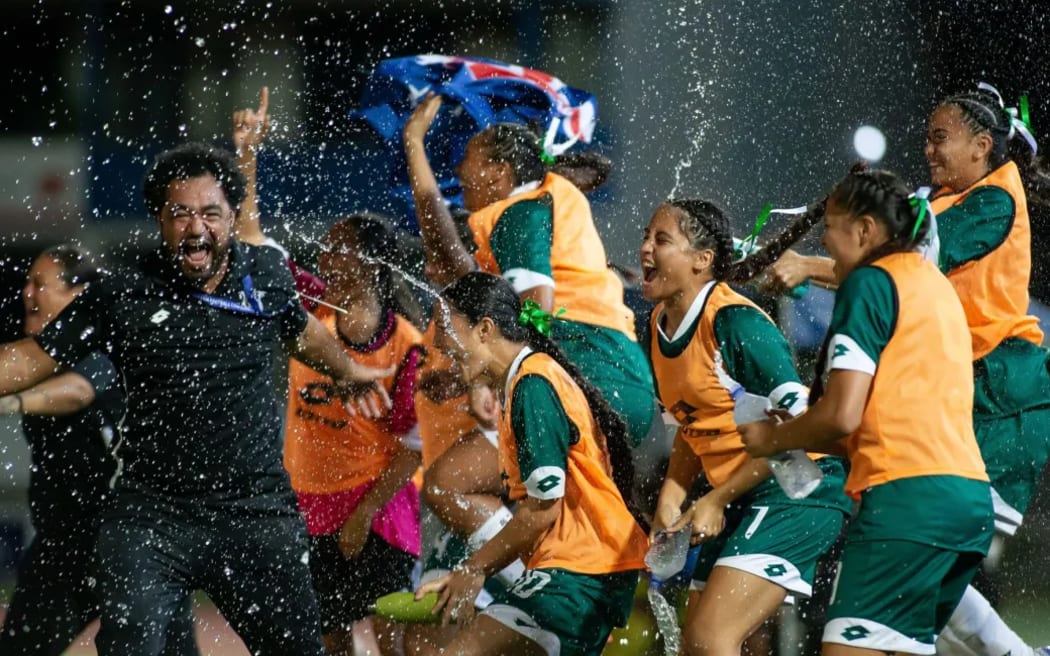 Players and coaches celebrate after the Cook Islands' win