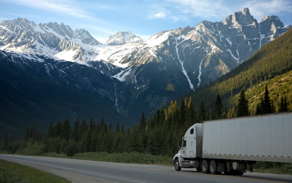 truck drives by mountains