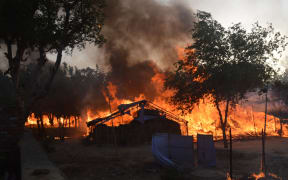 Former homes of Indian members of a sect burn following clashes with police during an eviction at the Jawahar Bagh park in Mathura on June 2, 2016.