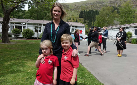 Chelsea Halliwell with her kids Georgie and Flynn, at today's announcement over the future of Redcliffs School.