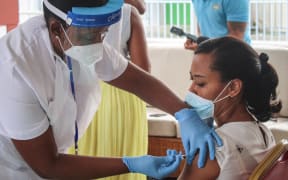 A medical personnel injects a dose of the Chinese Covid-19 vaccine produced by Sinopharm at the Seychelles Hospital in Victoria, on January 10, 2021.