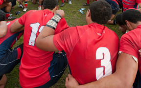 Kelston Boys High School players pray in a huddle after winning the NZ secondary schools boys rugby final for the Barbarian Cup 24-14 against Wesley College at Rotorua Boys High School, Rotorua, New Zealand, Sunday 28 August 2011.