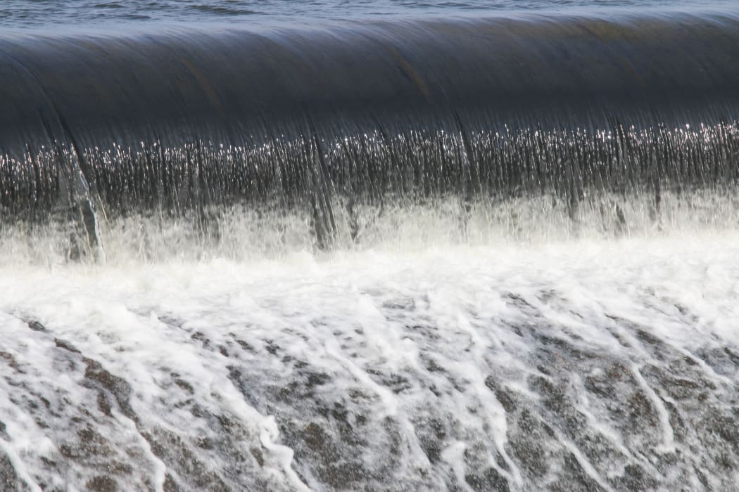 Building a man-made dam to store water for the dry season.