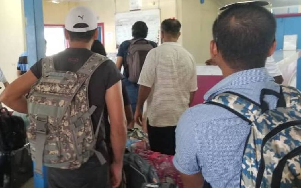 Manus Island refugees wait at the airport for their flight to Port Moresby.