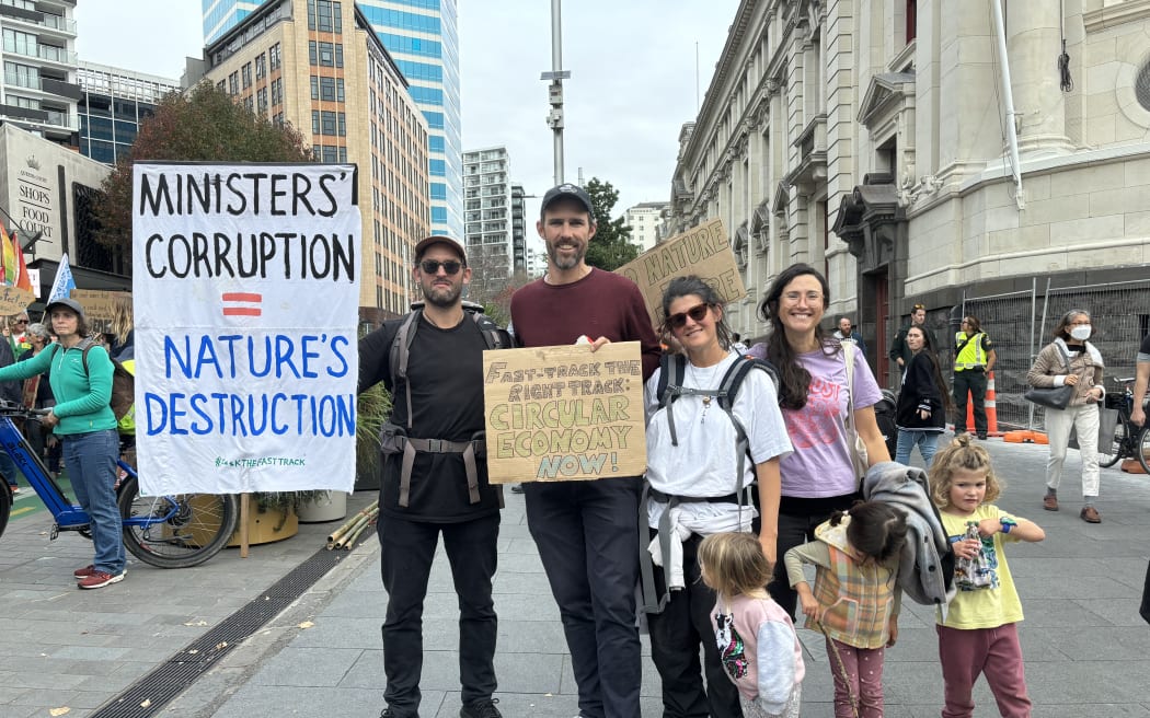 People holding placards protest against the government's Fast Track Bill near Aotea Square on 8 June 2024.