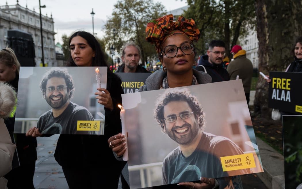 Supporters of the jailed British-Egyptian human rights activist Alaa Abd el-Fattah take part in a candlelight vigil outside Downing Street in London, United Kingdom as he begins a complete hunger strike while world leaders arrive for COP27 climate summit in Sharm el-Sheikh, Egypt.