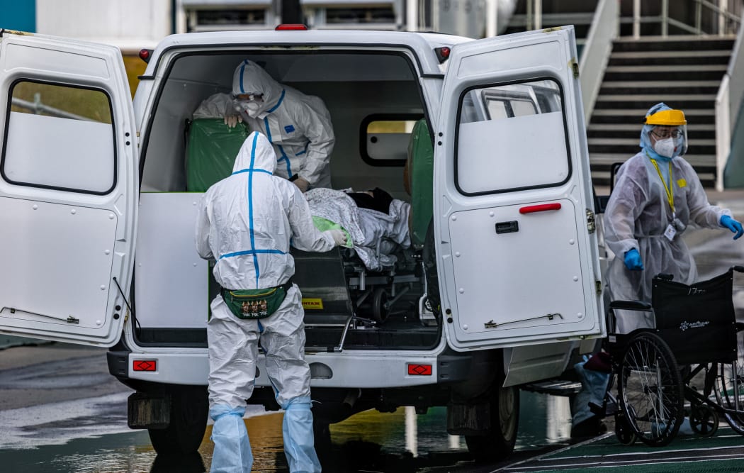Medical staff members carry out from an ambulance a person at the Covid-19 infected patients section at the Kommunarka Hospital outside Moscow on October 15, 2021.