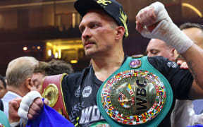 Ukraine's Oleksandr Usyk (C) celebrates his victory over Britain's Tyson Fury during a heavyweight boxing world championship fight at Kingdom Arena in Riyadh, Saudi Arabia on May 19, 2024. Oleksandr Usyk beat Tyson Fury by split decision to win the world's first undisputed heavyweight championship in 25 years on May 19, 2024, an unprecedented feat in boxing's four-belt era. (Photo by Fayez NURELDINE / AFP)