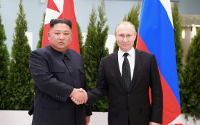This picture taken on April 25, 2019 and released by North Korea's official Korean Central News Agency (KCNA) on April 26 shows Russian President Vladimir Putin (R) and North Korean leader Kim Jong Un shaking hands as they pose for pictures prior to their talks at the Far Eastern Federal University campus on Russky island in the far-eastern Russian port of Vladivostok.