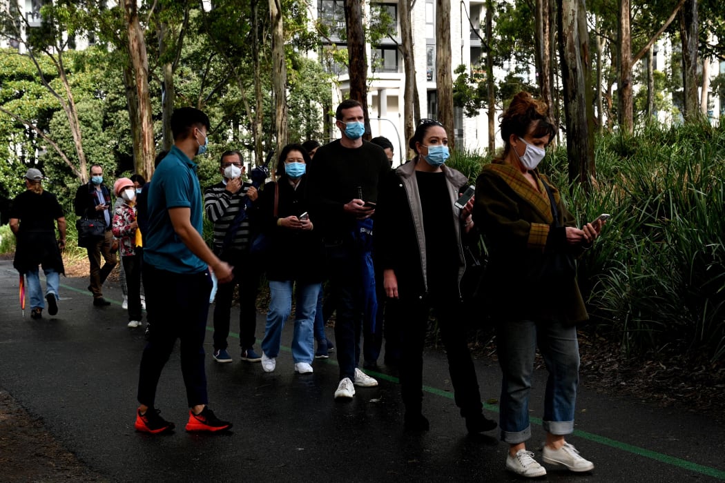 Sydneysiders queue outside a vaccination centre in Sydney on June 29, 2021, as about 10 million Australians have been ordered into lockdown.