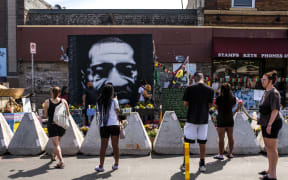People gathering at George Floyd Square, where a memorial was placed to him.