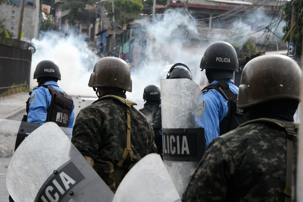 Supporters of presidential challenger Salvador Nasralla of the Honduran Opposition Alliance Against the Dictatorship, clash with  police in Tegucigalpa on Saturday, 20 January.