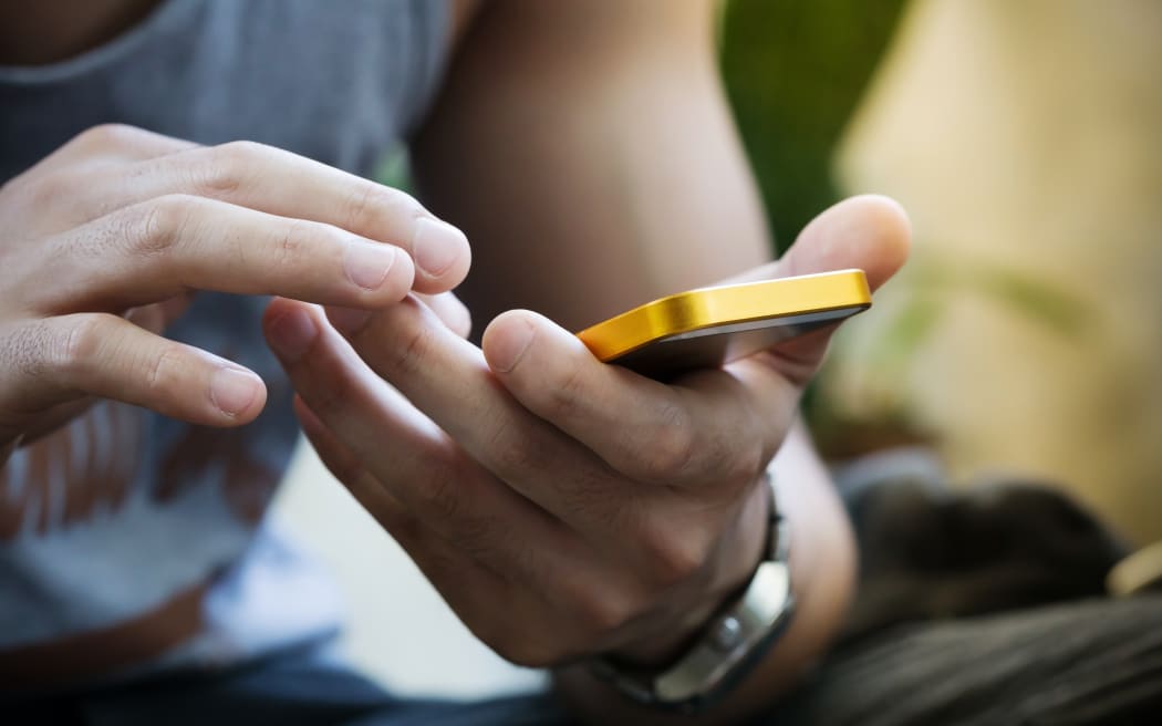 lifestyle young man using a mobile phone with texting message on app smartphone, playing social network and shopping online