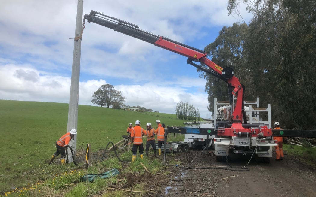 The team at working installing a new power pole in Ermedale, rural Southland.