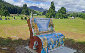 Newly installed Peter Rabbit thinking seat in Garston cemetery