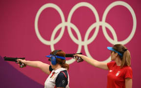 Georgia's Nino Salukvadze (R) and Serbia's Jasmina Milovanovic compete in the women’s 10m air pistol qualification during the Tokyo 2020 Olympic Games at the Asaka Shooting Range in the Nerima district of Tokyo on July 25, 2021. (Photo by Tauseef MUSTAFA / AFP)
