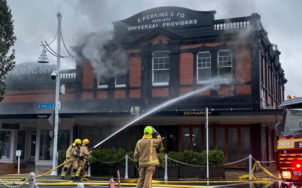 Firefighters fighting the blaze in a two-story building on King Street in Pukekohe, Auckland.