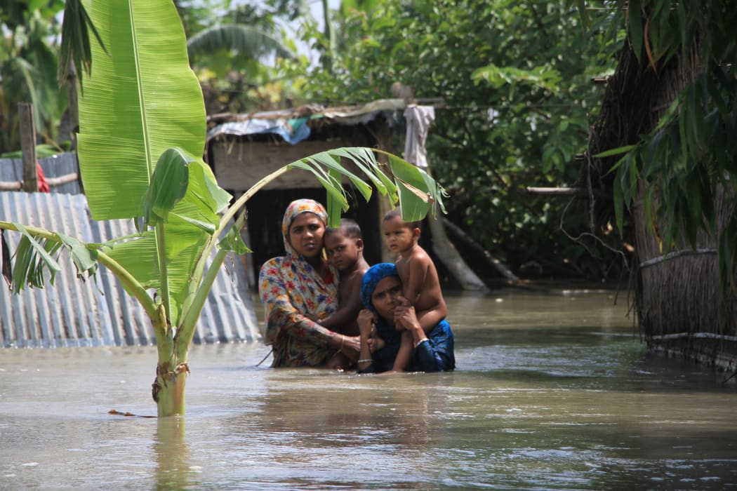 Bangladeshi flood victims look for relief materials in Kurigram, northern Bangladesh on 16 August.