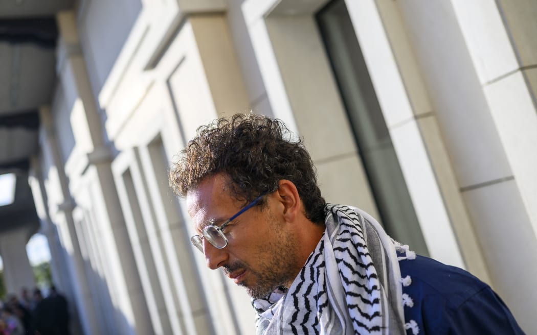 Lorenzo D'Agostino of Italy, one of the activists who were sailing aboard vessels from the Global Sumud Flotilla, speaks to the press after arriving with thirty-six Turks and nationals from 12 countries at Istanbul Airport on a special flight, after Israel stopped a Gaza-bound aid flotilla and detained hundreds of people, in Istanbul on October 4, 2025. "We expect 36 of our nationals on the Global Sumud Flotilla vessels seized by Israeli forces in international waters will return to our country this afternoon via a special flight," Turkish foreign ministry spokesman Oncu Keceli said on X, adding that the number has not been finalised. The Turkish diplomatic source said nationals from the United States, United Arab Emirates, Algeria, Morocco, Italy, Kuwait, Libya, Malaysia, Mauritania, Switzerland, Tunisia, and Jordan planned to be on the Turkish Airlines flight. (Photo by Yasin AKGUL / AFP)