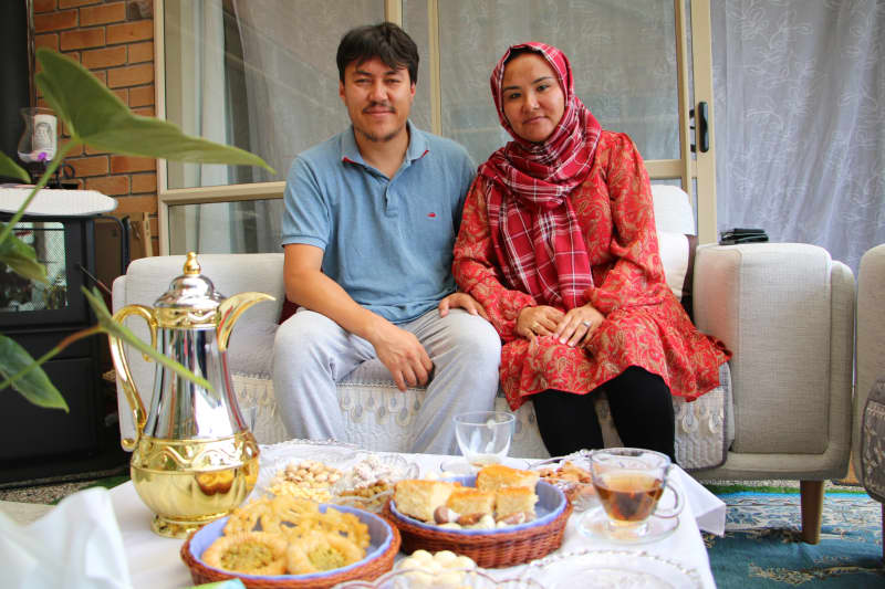 Shookria Basir and Enayatullah Basir, originally from Afghanistan's Ghazni, at their Auckland home with a spread of traditional sweets and tea.