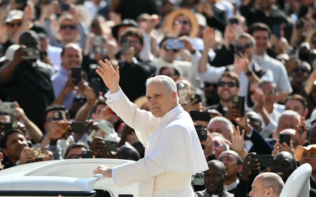 Pope Leo XIV greets the crowd from the popemobile before a Holy mass for the beginning of his pontificate, in St Peter's square in The Vatican on May 18, 2025. (Photo by Alberto PIZZOLI / AFP)