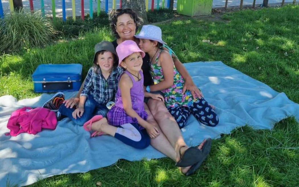 A photo posted on social media by Cat of her and her three missing children during a visit to the park in November 2021 before they were taken by their father, Tom Phillips.