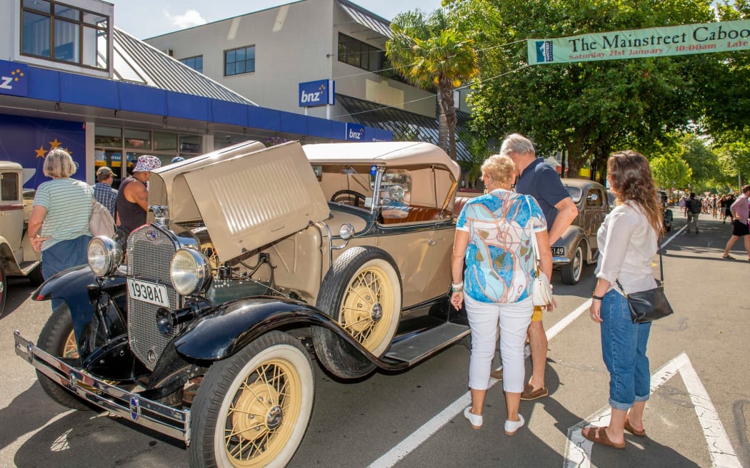 Checking out a vintage car on Whanganui's Victoria Ave.