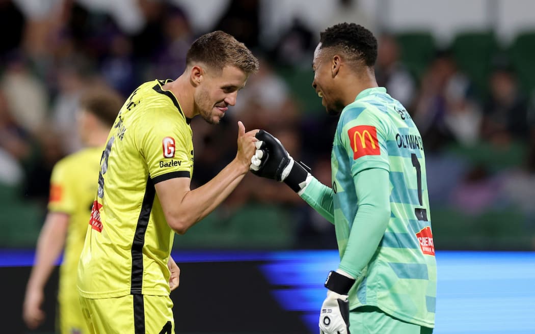 Scott Wootton and Josh Oluwayemi of the Phoenix celebrate after winning the A-League Men Round 2 match between Perth Glory and Wellington Phoenix.