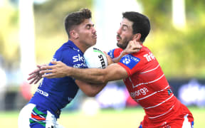Chanel Harris-Tavita (left) of the Warriors is tackled by Ben Hunt (right) of the Dragons