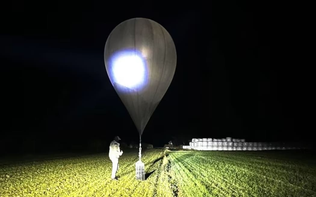 An officer inspects a balloon used to smuggle cigarettes into Lithuania by Belarusian smugglers, in an undated photo released by the State Border Guard Service.