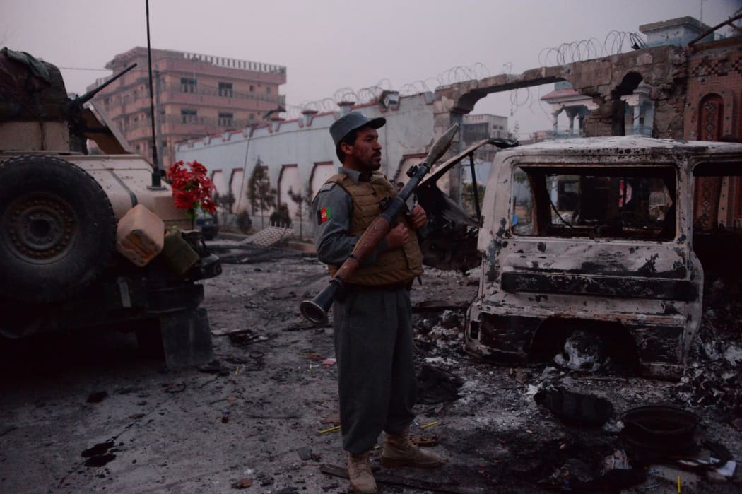 Afghan security forces inspect the site of attack on British charity Save the Children office in Jalalabad on January 24, 2018.