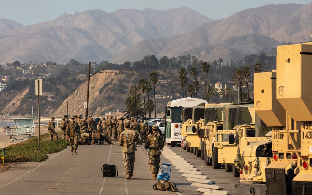 Members of the Army National Guard eat lunch along Pacific Coast Highway while on deployment to assist with various fires in Los Angeles on January 10, 2025. Massive wildfires that engulfed whole neighborhoods and displaced thousands in Los Angeles have killed at least 10 people, authorities said, as California's National Guard soldiers readied to hit the streets to help quell disorder.
News of the growing toll, announced late Thursday January 9 by the Los Angeles County Medical Examiner, came as swaths of the United States' second-largest city lay in ruins. (Photo by Zoë Meyers / AFP)