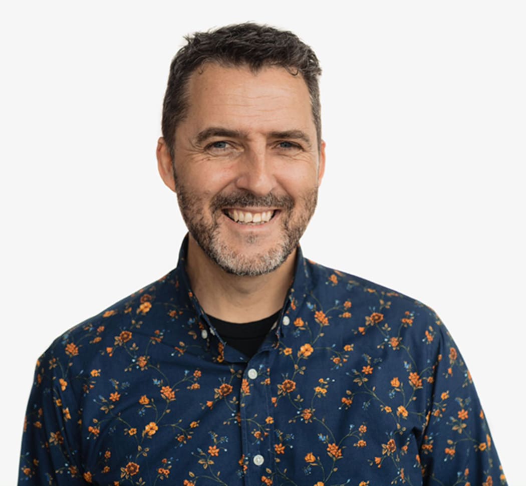 Photo of a man smiling to camera.