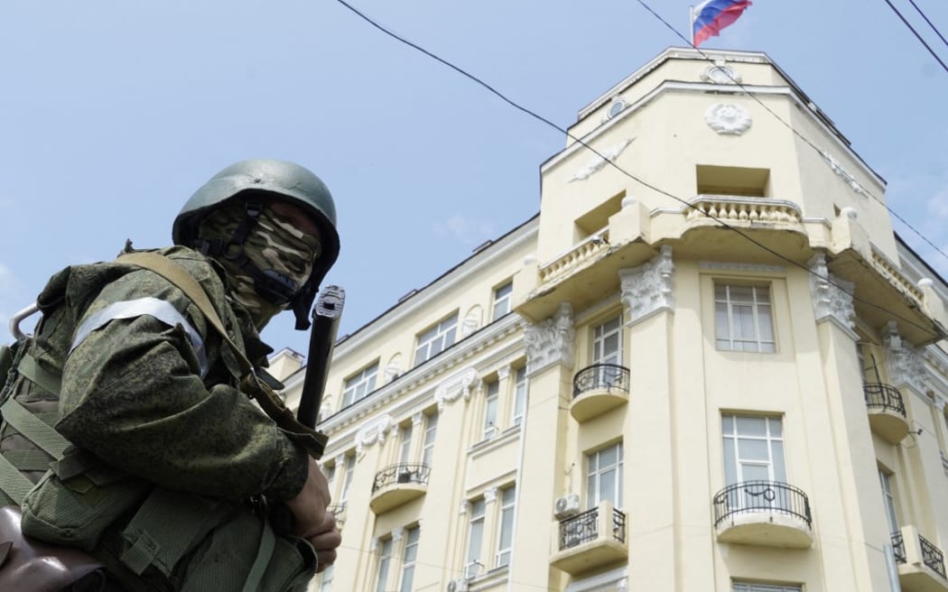 A member of Wagner group stands guard in a street in the Russian city of Rostov-on-Don, on June 24, 2023.