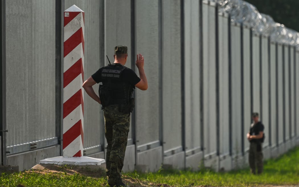 Polish border guards near the new fence on the Polish-Belarusian border near the village of Nowdziel. The border wall on the Polish-Belarusian border was built with the use of 50,000 tons of steel. It is 5.5 meters high,  topped with a razor wire and it stretches for 186.25 km. On Thursday, June 30, 2022, in Nowodziel, near Kuznica, Podlaskie Voivodeship, Poland.