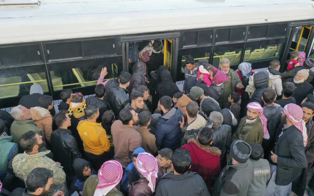 Syrian refugees living in Turkey waiting to take a bus through the northern Bab al-Hawa border crossing, on 17 February, 2023, as they return to Syria in the aftermath of a deadly earthquake.