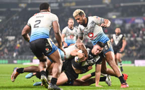 Joseph Manu of New Zealand attempts to break through against Fiji in their Quarter Final of the Rugby League World Cup England 2022.