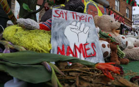 People lay flowers at a memorial in George Floyd Square in Minneapolis, Minnesota, United States on April 21, 2021.