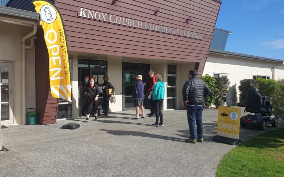 People queue to sign in at Tui Ora's pop up clinic in Waitara.