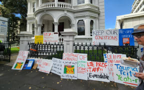 More than 100 University of Auckland staff and supporters rally for workers' rights on Princes Street on 1 March, 2023.