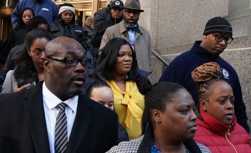 Metropolitan Correctional Center guard Tova Noel (yellow shirt) surrounded by supporters leaves Federal Court in New York City in November, 2019