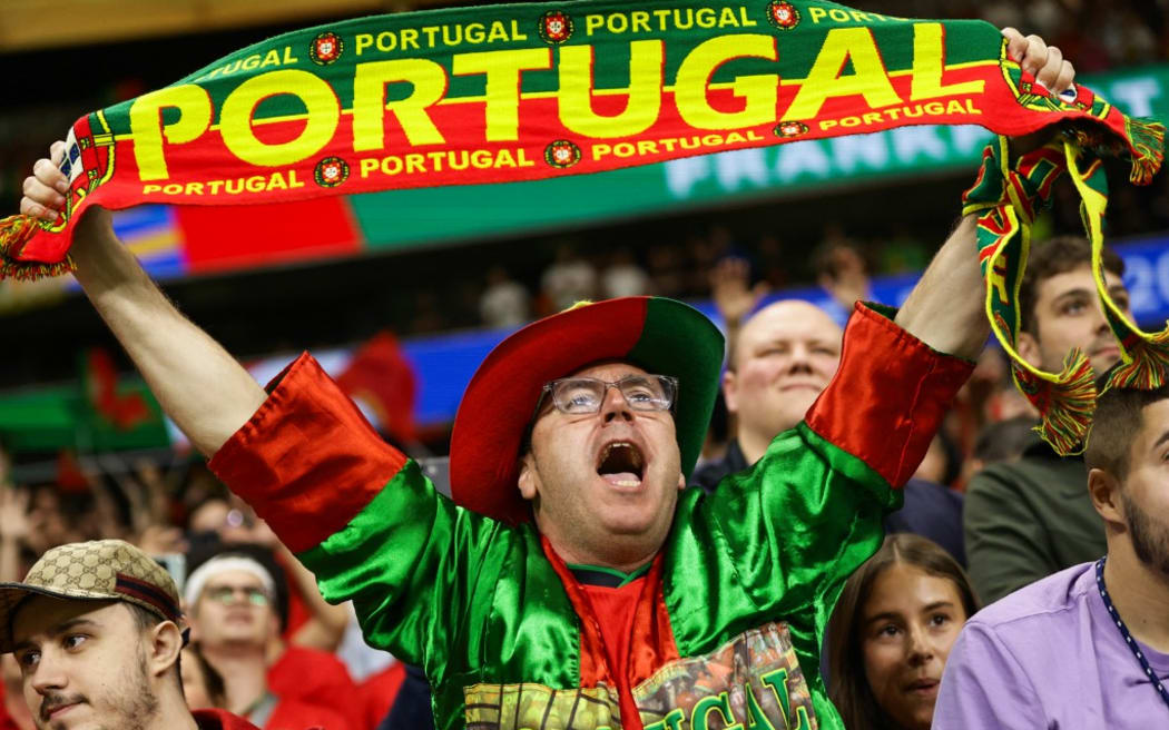 A Portugal supporter is cheering during the UEFA Euro 2024 round of 16 football match between Portugal and Slovenia at the Frankfurt Arena in Frankfurt am Main (Photo by Ibrahim Ezzat/NurPhoto). (Photo by Ibrahim Ezzat / NurPhoto / NurPhoto via AFP)