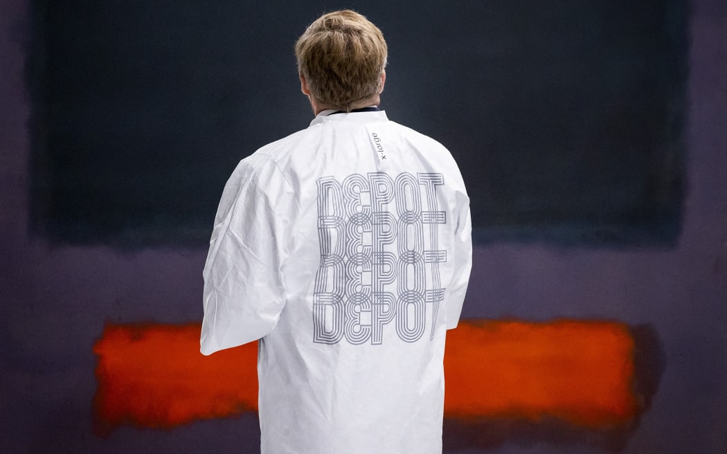 King Willem Alexander stands in front of Mark Rothko's Grey, Orange on Maroon, No. 8 during a tour of Depot Boijmans Van Beuningen on 5 November 2021. The art collection of Museum Boijmans van Beuningen is stored in the building. ANP ROYAL IMAGES KOEN VAN WEEL (Photo by Koen van Weel / ANP MAG / ANP via AFP)
