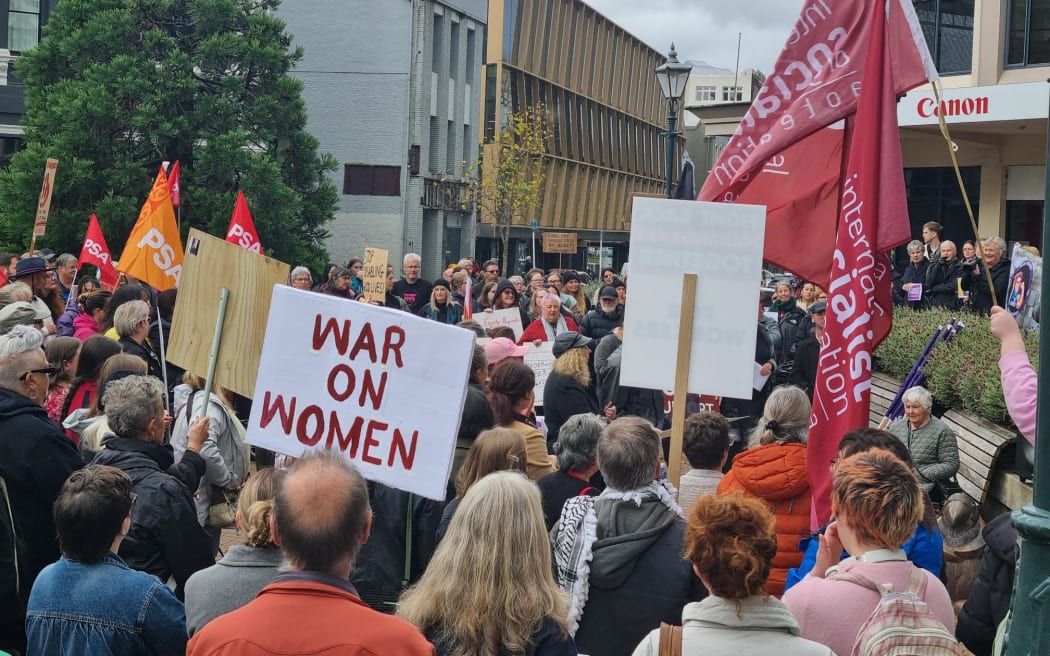 In Dunedin, more than 100 protesters have packed John Wickliffe Square, chanting "What's outrageous? Gendered wages"