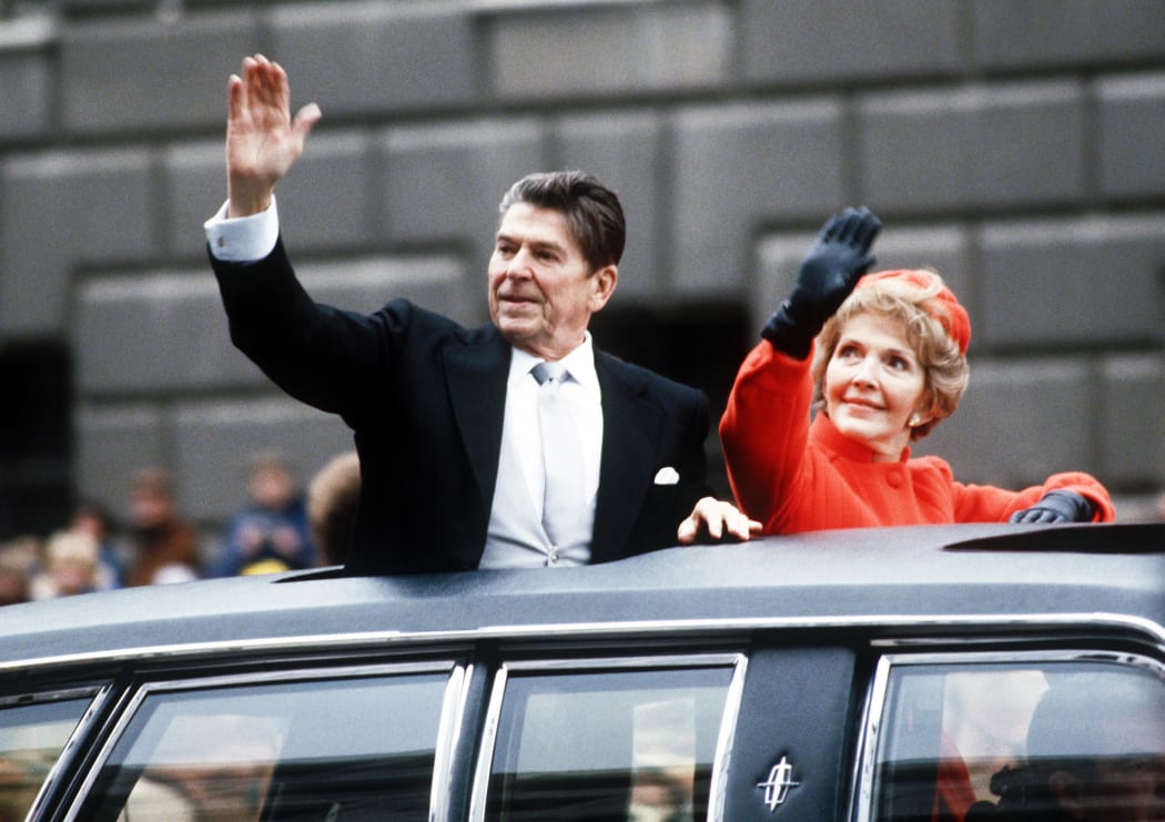 40th U.S. President Ronald REAGAN 1911-2004 and First Lady Nancy Reagan wave to the crowd waiting along the Inaugural parade route down Pennsylvania Avenue, Washington DC, 20 January 1981