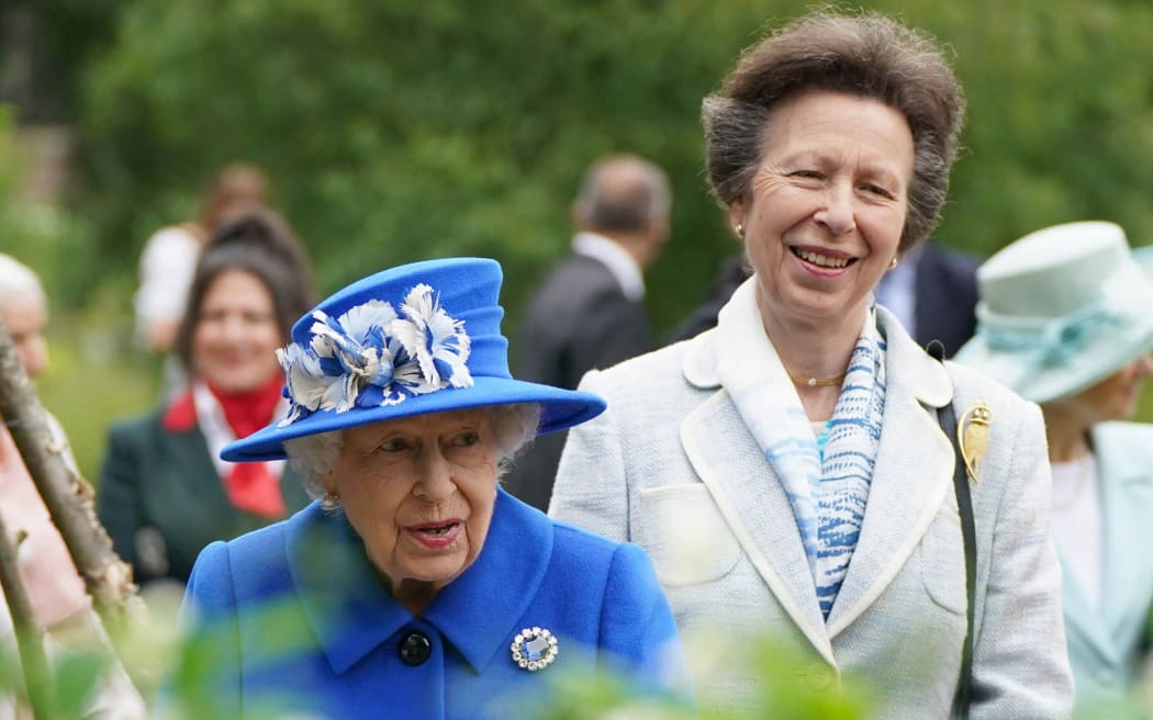 Britain's Queen Elizabeth II and Britain's Princess Anne, Princess Royal gesture during a visit to The Children’s Wood Project in Glasgow on June 30, 2021, as part of her traditional trip to Scotland for Holyrood Week. (Photo by Andrew Milligan / POOL / AFP)