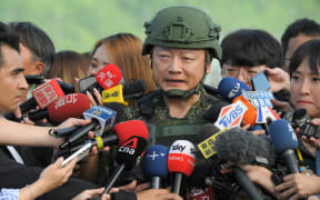 Sun Li-fang (C), spokesperson of Taiwan's Defence Ministry, speaks to the media at an airforce base during an inspection of the troops as part of Taiwan's annual Han Kuang military drills in Hualien on 23 July 2024.