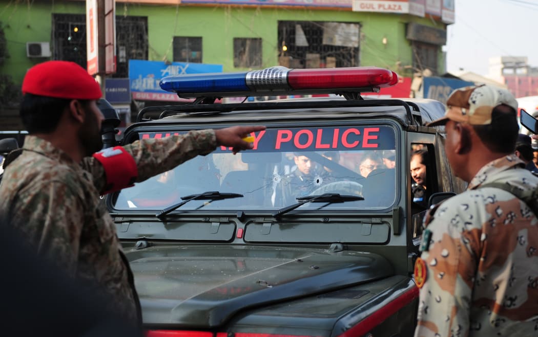 Pakistani security officials inspect a military police jeep following an attack by gunmen in Karachi on 1 December 2015.