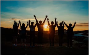 Teenagers at the beach at sunset