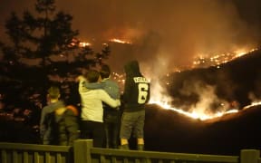 Residents watch the fires burn along Worsley Road and Cracroft, from Dyers Pass Road.